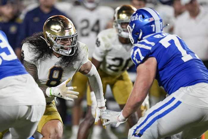 Sep 30, 2023; Durham, North Carolina, USA; Notre Dame Fighting Irish linebacker Marist Liufau (8) fends off a block by Duke Blue Devils offensive lineman Justin Pickett (77) during the second half at Wallace Wade Stadium. Mandatory Credit: Jim Dedmon-USA TODAY Sports  